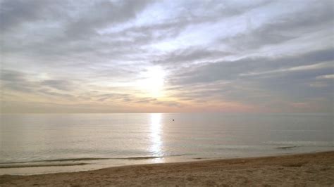 Sunrise beach. Idyllic scene of sea sunrise. Sea waves slowly splashing sand. Sunrise sea ...