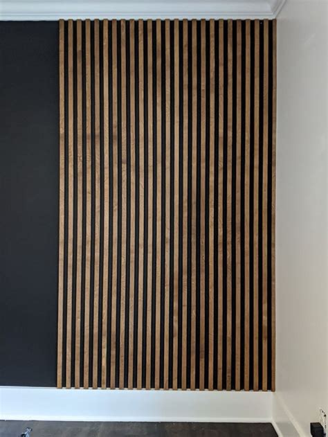 Stained-wood-slat-wall-installed-on-black-wall-progress | Wood slat wall, Slat wall, Wall paneling