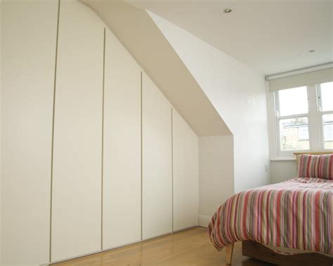 Contemporary fitted wardrobes for a loft bedroom with ‘his and hers’ sections including two sets ...