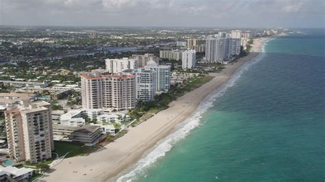 5K stock footage aerial video of following the beach along the coast, Pompano Beach, Florida ...