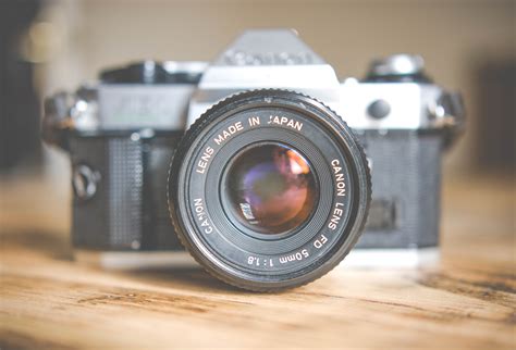 canon lens on a vintage canon camera on a wooden surface, vintage canon ...