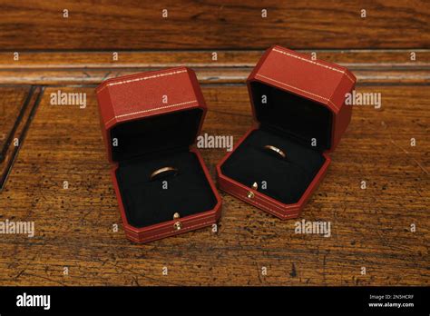 Golden wedding rings in Cartier ring box Stock Photo - Alamy