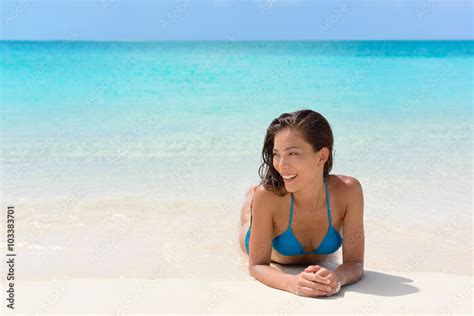 Beach vacation woman relaxing on sand happy. Asian mixed race model ...