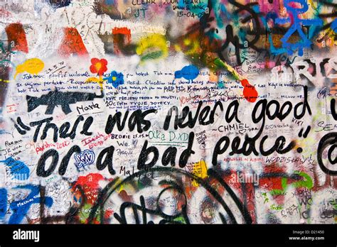 Urban graffiti street art slogan words on John Lennon Wall Prague Stock ...