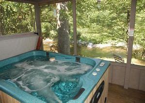 Hot tub on the deck overlooking the river at the Bear Cabin in the ...