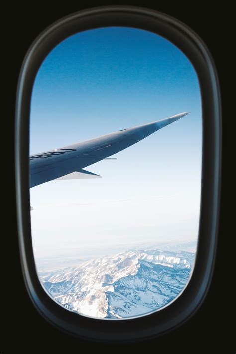 Gray Planes Right Wing With View of Snow-covered Mountains View from ...