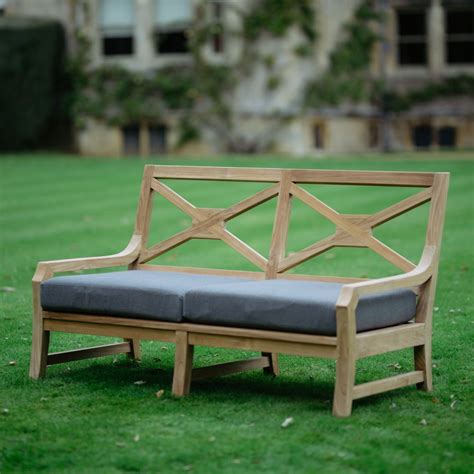 This two-seater sofa armchair has been crafted from sustainable teak ...