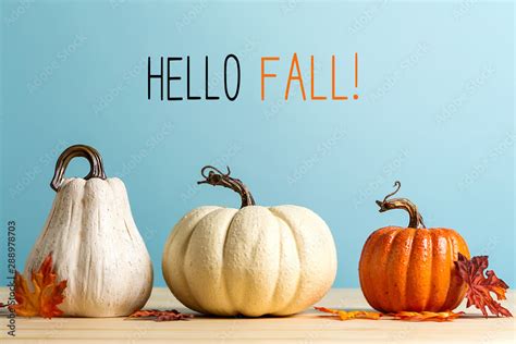 Hello fall message with pumpkins on a blue background Stock Photo | Adobe Stock