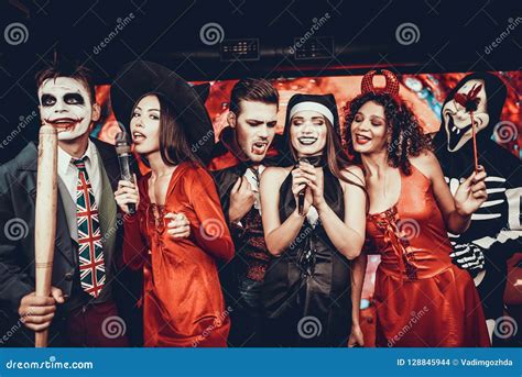 Young People in Halloween Costumes Singing Karaoke Stock Photo - Image of clubbing, party: 128845944