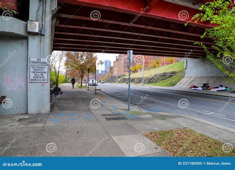 A Freeway Underpass with Homeless People Sleeping Underneath with Man ...