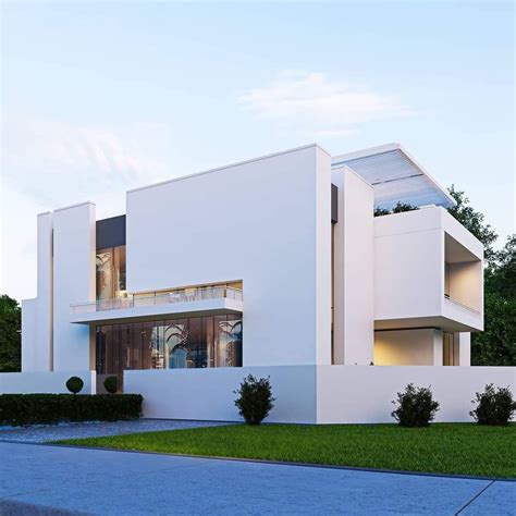 a white modern house is shown in the evening