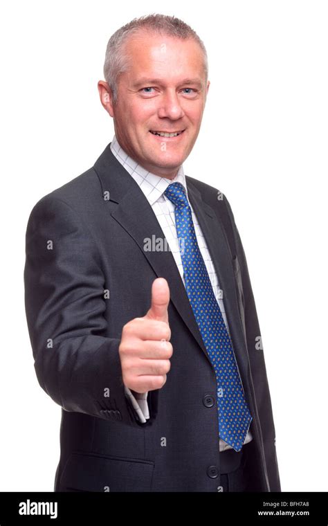 Mature businessman in suit and tie giving a thumbs up gesture towards camera, isolated on a ...