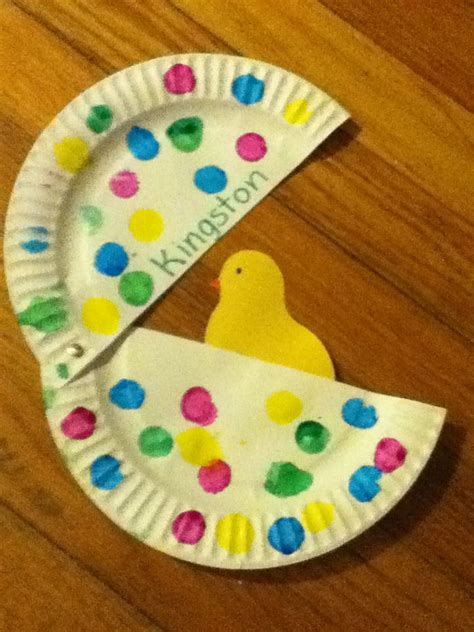 a paper plate with a yellow bird on it and polka doted paper around the ...