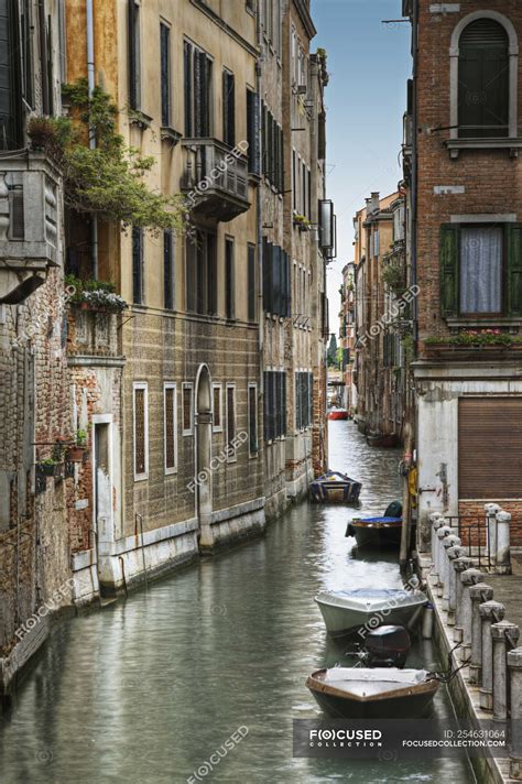 Houses and boats on water along canal, Venice, Italy — anchored, city - Stock Photo | #254631064