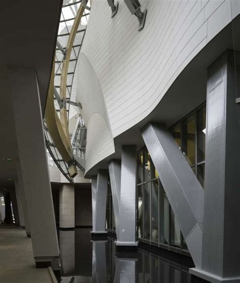 the inside of a building with stairs and windows