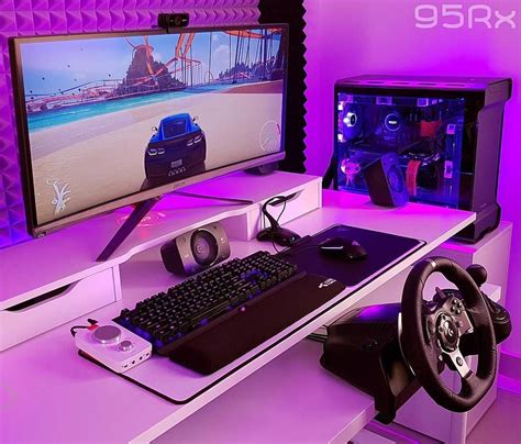 a computer desk with a keyboard, mouse and video game controller in front of it