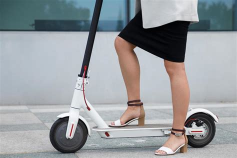 Female legs on the electric scooter 14406252 Stock Photo at Vecteezy