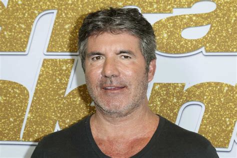 Simon Cowell breaks his back