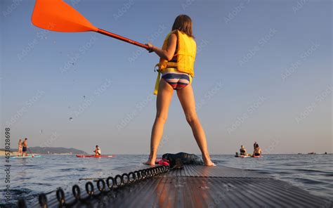 sup surfing in the sea Stock Photo | Adobe Stock