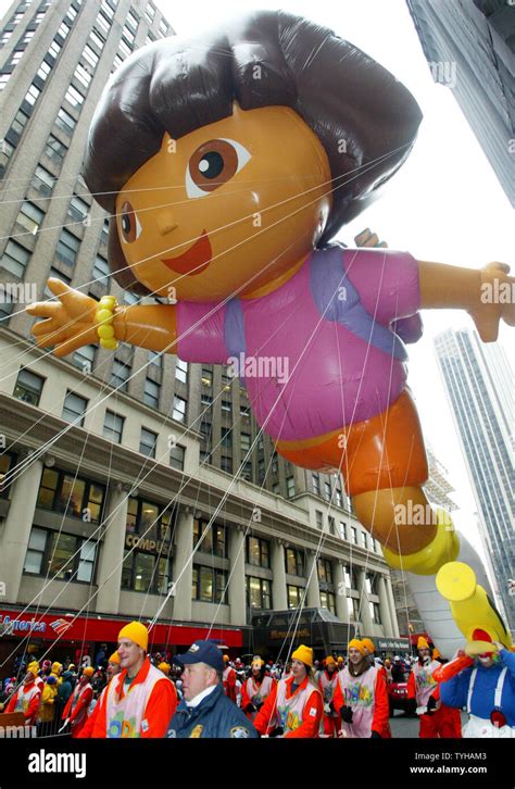 The Dora the Explorer giant helium balloon makes it's debut as it is guided down Broadway during ...