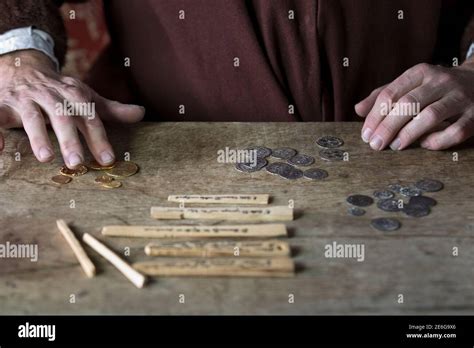 Medieval merchant counting money using tally sticks Stock Photo - Alamy