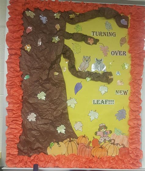a bulletin board with an image of a tree and pumpkins on the front wall