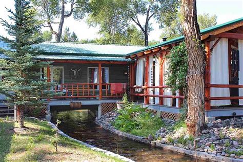 10 Pics of a Wyoming Log Cabin with a Canal Running Under It