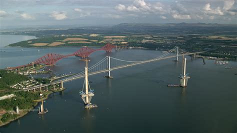 5.5K stock footage aerial video of a view of the Forth Road Bridge and Forth Bridge on Firth of ...