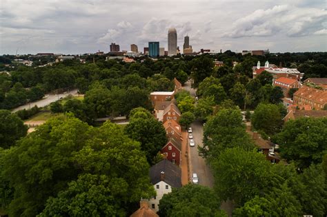 Old Salem Museums & Gardens Aerial Shot with Downtown Winston-Salem in ...