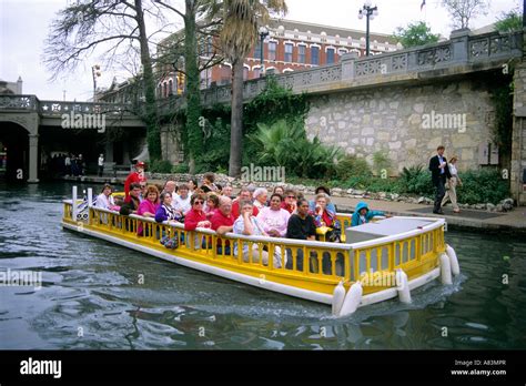 Visitors on a boat tour along the River Walk in San Antonio Texas Stock ...