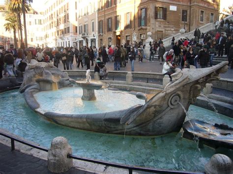 The Fontana della Barcaccia fountain at the Piazza di Spagna square ...