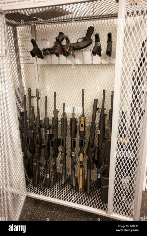 arsenal of weapons cage of assault rifles handguns and shotguns at a Stock Photo - Alamy