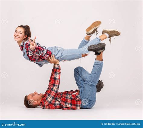 A Young Happy Couple Doing Acrobatic Stunts. Isolated on White Background. Stock Image - Image ...