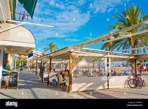 Restaurant terrace by Platja d'Alcudia beach, Port d'Alcudia, Mallorca ...