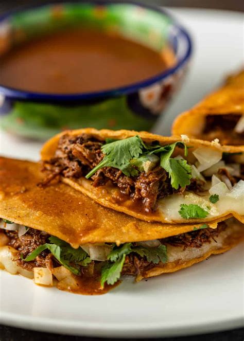 Birria tacos are made from tender lamb or beef in a rich adobo sauce ...