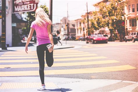 Athletic Woman Stretching Legs Before Running