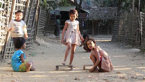 Children Brother And Sister Playing Game In The Park. Two Little Gypsy Kids Sitting On A Seesaw ...