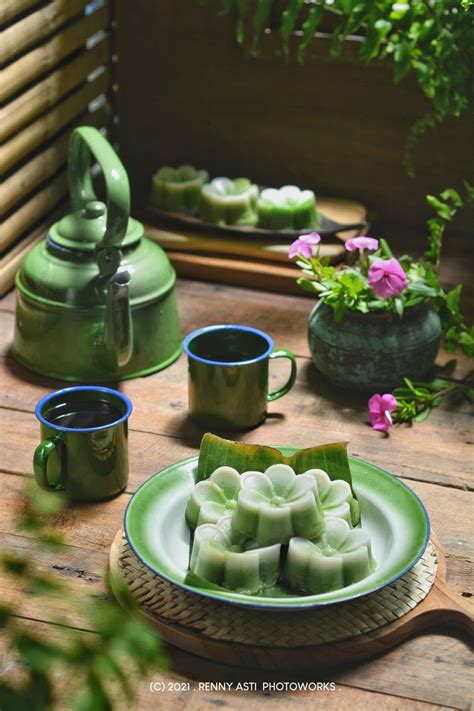 green tea cakes on a plate with cups and saucers next to potted plants