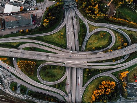 Aerial shot of twisted roads surrounded by parks in the middle of the ...