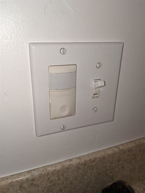 What kind of light switch is on the left (in the bathroom)? What is the ...