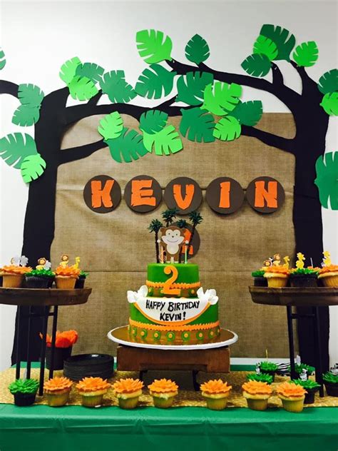 Jungle themed birthday party with DIY decorations, backdrop, and yummy ...