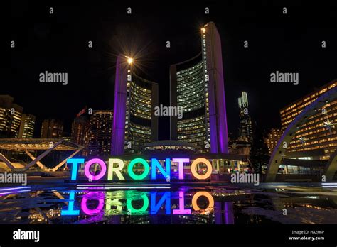 Toronto Sign with the illuminated City Hall at night, in Toronto ...