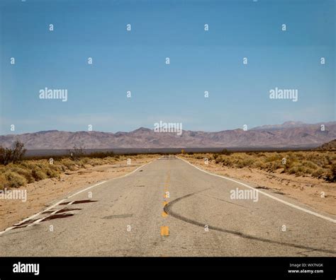 Road through the desert in Nevada Stock Photo - Alamy