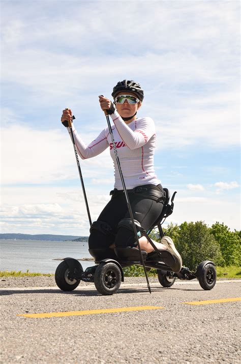 a woman riding an electric scooter on the road with poles in her hand