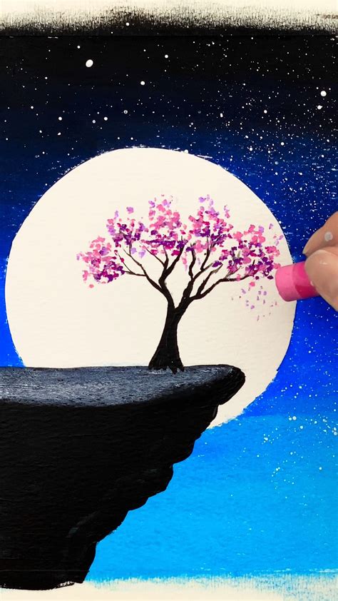 someone is painting a tree on the edge of a cliff with water and stars ...