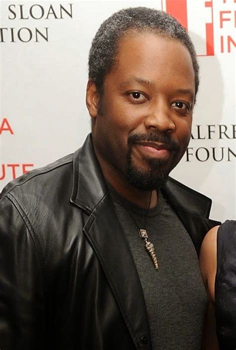 a man in a black leather jacket posing for the camera