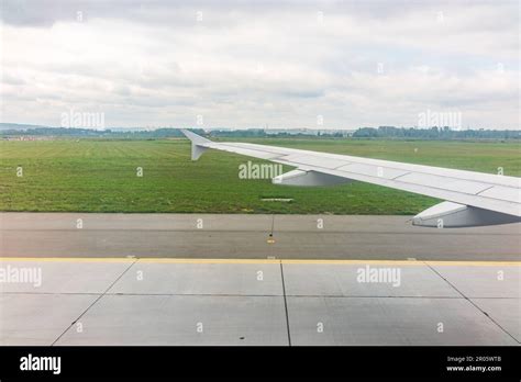 View of airplane wing, blue skies and green land during landing ...