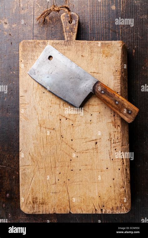 Chopping board and Meat cleaver on dark wooden background Stock Photo ...