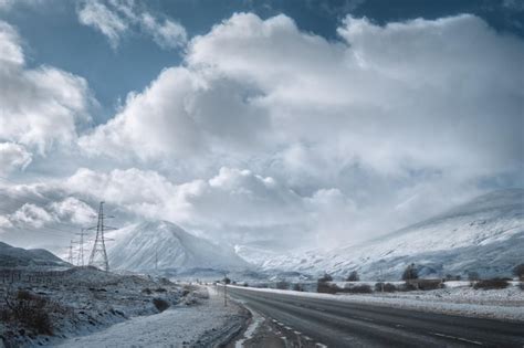 Premium Photo | Winter road through scottish highlands and snowy mountains scotland united kingdom