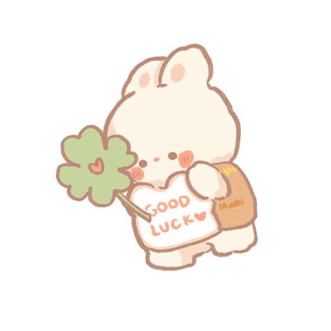 a white cat holding a green leaf in it's hand with the words good luck written on it